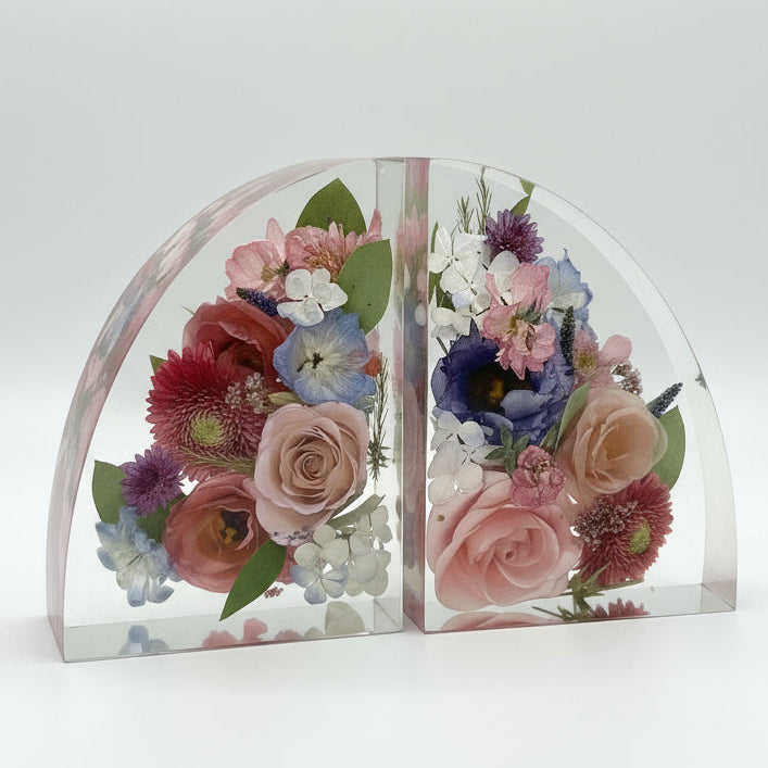 Floral bookends in  crystal-clear resin on a white background