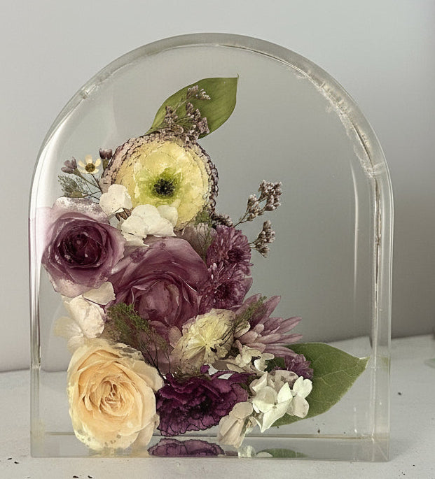 Floral preservation with purple tones in an 8" arch
